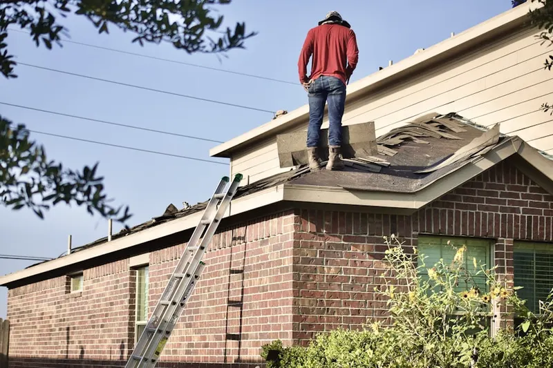 Professional roofer working on a residential roof in Thurmont